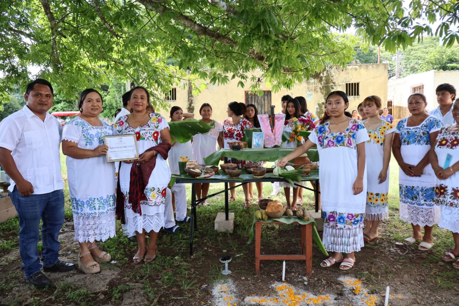 Habitantes y estudiantes participan en la demostración de altares y el Paseo de Ánimas por el Hanal Pixán en Eknakan, Yucatán.